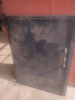 Full view of metal cabinet door showing glass panel, handle, and hinge