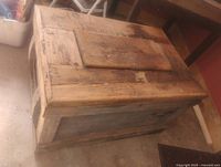 closed wooden chest showing exterior wear and iron side handle