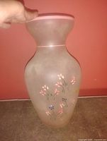 Frosted glass vase front view showing floral painting and pink rim