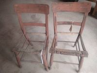 Front view of both antique wooden chairs missing seats