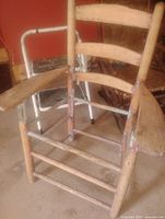Front view of wooden ladder back armchair frame showing missing seat and armrests