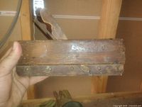 Side view of wooden molding plane showing body, metal sole plate, cutter wedge