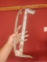 Side view of entire metal brick carrier held in hand