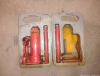 Bottle jack, handles and case open showing contents