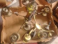 Top view of entire brass chandelier showing six arms, central column, wiring, sockets