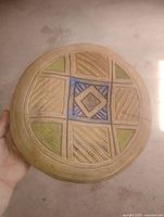 exterior base showing full carved and painted geometric design