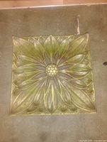 Square panel with large flower relief