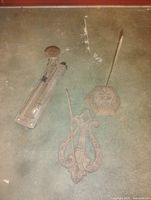 Overall view of three cast iron items on floor