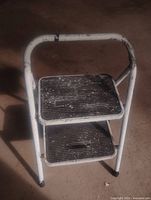 Front view of metal two-step folding ladder
