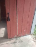 Full length view of rake leaning against wall