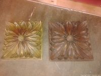 Two square floral relief panels side by side