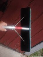 Angled view of shovel head showing aluminum connector and support rods