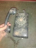 Front view showing rotary dial, cradle, handset