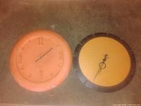 Front view of both clocks side by side