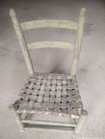 Full view of antique Shaker style chair showing woven seat and ladder-back