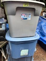 Two stacked totes: grey Sterilite on top, blue type A below, both with lids visible
