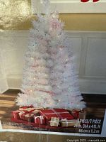 Retail box showing full view of assembled white pre-lit tree