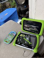 LeapFrog LeapPad Epic and Academy tablets next to VTech Peppa Pig phone