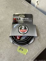 Front view of packaged Bell Ballistic 410 cable lock showing brand, model, security level, and cable coiled