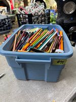 top view of blue tote filled with writing instruments and accessories