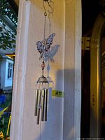 Full view of butterfly wind chime hanging from hook