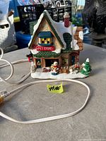 Front view of porcelain pet store building with cord visible