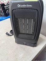 Front view of Comfort Zone heater showing grille and brand logo