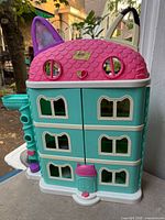 Front view closed showing cat-ear roof and windows