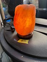 Lamp illuminated displaying orange glow, cord and switch visible