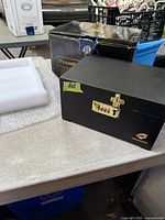 Closed Hovanzo stash box beside original packaging