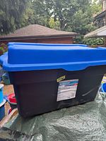 Entire tote showing black body and blue lid