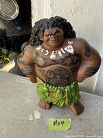 Front view of Disney Moana Maui action figure with tattoos, necklace and leaf skirt