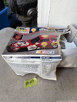 Damaged side of Revell Monogram model kit box showing product information and NASCAR logo