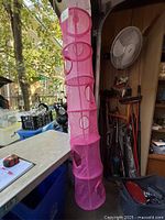 Full view of pink six-tier mesh hanging basket showing size and compartments