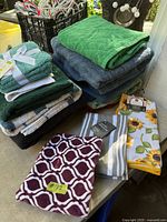 Full lot showing stacks of bath towels, washcloth pack and kitchen towels