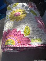 Folded floral quilt showing pattern and border