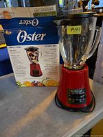 Blender in front of original box showing complete set