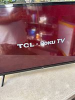 Front view of TCL Roku TV displaying logo