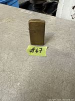 Front view of brass Zippo lighter standing upright