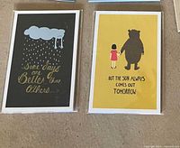 Both small art prints side by side in sleeves