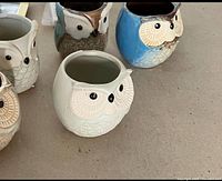 Six ceramic owl holders, various colors