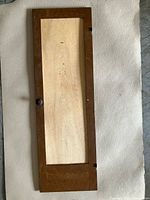 Full view of wooden dresser door panel on floor