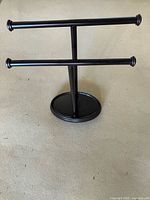 Overall view of metal freestanding hand towel holder showing two bars and base