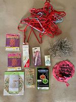 All items spread out showing hangers, packaged lanterns, whoopee cushion, small packaged items, napkin rings