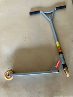 Full view of scooter showing deck, wheels, handle, Supreme decal