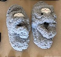 Top view of gray plush cat slippers