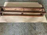 Front view of wooden open-frame shelf