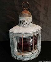 Front view of galvanized metal ship lantern with red lens