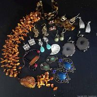 All jewellery pieces laid out including necklace, cuff, bracelets, earrings, brooch