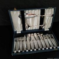 Open presentation case showing entire 14-piece fish flatware set